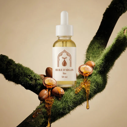 Flacon d’huile d’argan bio en verre ambré, pipette blanche, sur noix d’argan