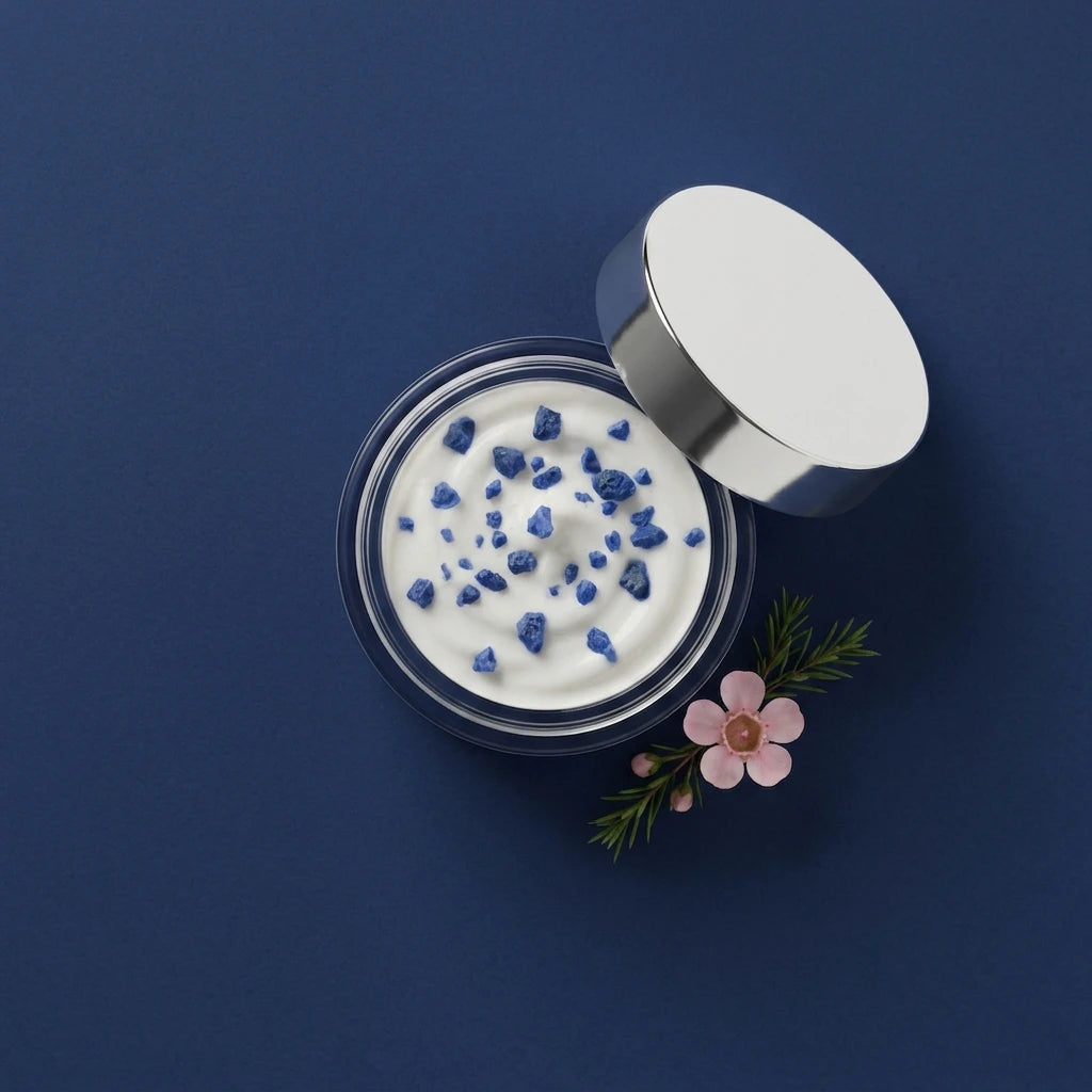 Pot de crème de jour hydratante ouvert, crème blanche texturée et couvercle blanc, vue de dessus
