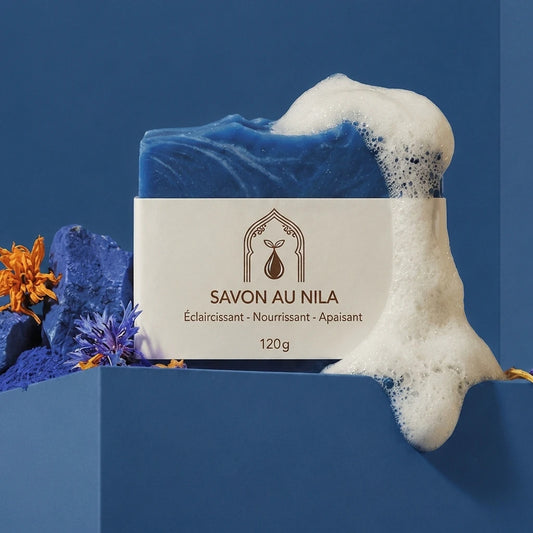 Savon bleu avec mousse blanche et étiquette beige « SAVON AU NILA », 120 g.