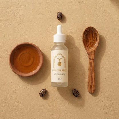 Huile de ricin en bouteille blanche, bol brun et cuillère en bois